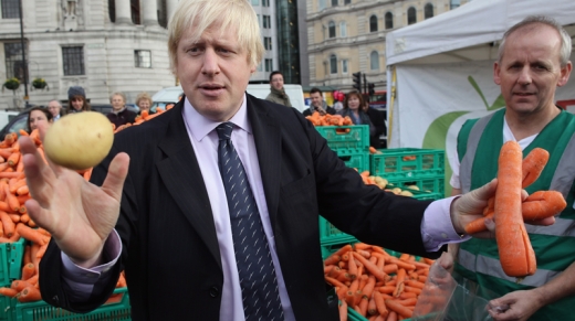 LONDON, ENGLAND - NOVEMBER 18:  Boris Johnson, the Mayor of London holds oddly shaped vegetables at a free food event on November 18, 2011 in London, England.  The 'Feed The 5,000' free lunch event took place in London's Trafalgar Square and was aimed at raising awareness of the financial impact of throwing good food away.  (Photo by Dan Kitwood/Getty Images)