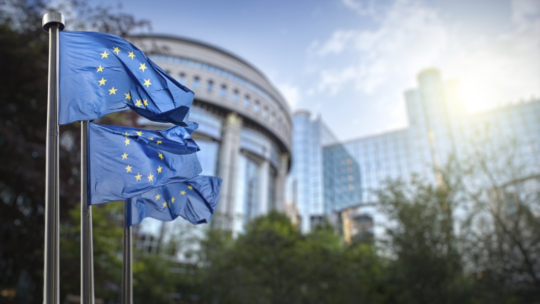 European union flag against parliament in Brussels, Belgium