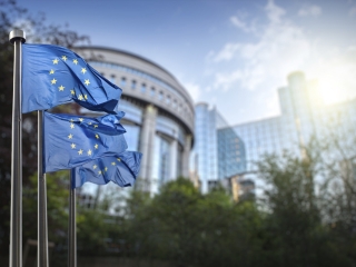 European union flag against parliament in Brussels, Belgium