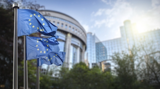 European union flag against parliament in Brussels, Belgium